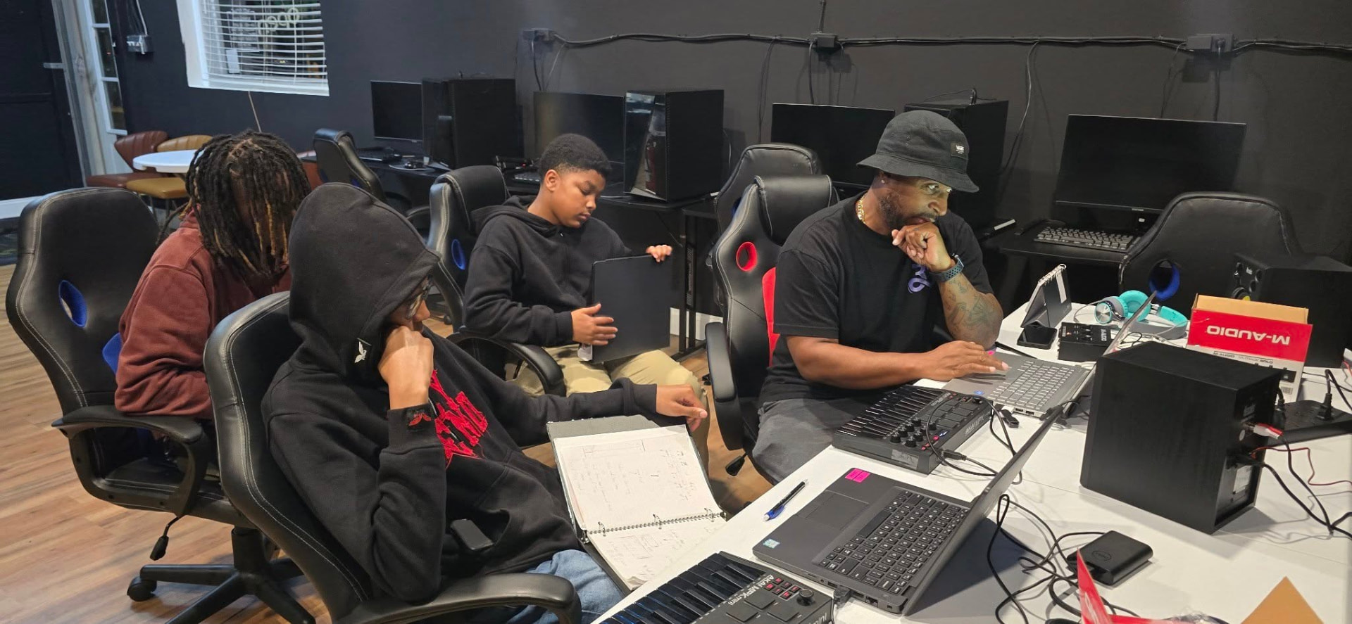 Youth working at computers in the New Avenue gaming and tech lab