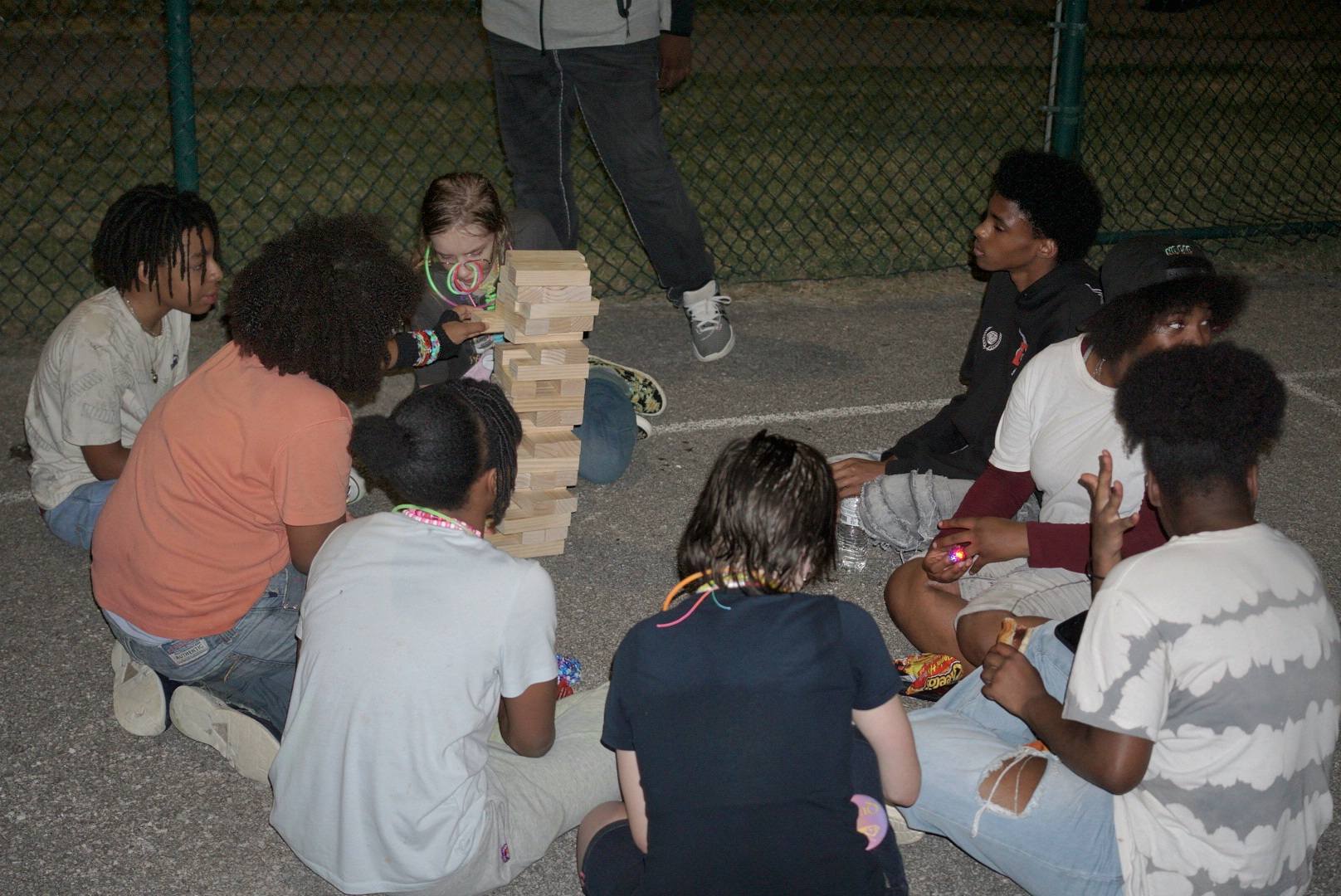 Youth playing giant Jenga together at a New Avenue event